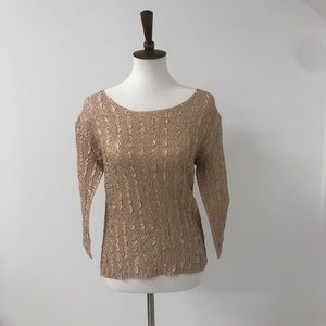 A gold very stretchy long sleeve shirt